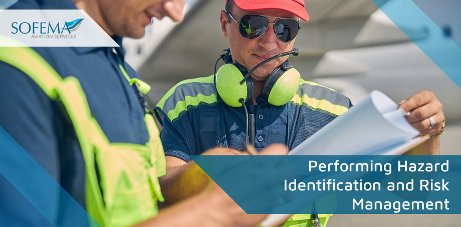 Two aviation maintenance personnel reviewing documents on the airfield, wearing safety gear and high-visibility clothing. The Sofema Aviation Services logo is in the top-left corner, with a text overlay focusing on hazard identification and risk management.